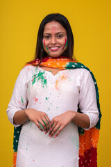 Portraits of young woman celebrating holi