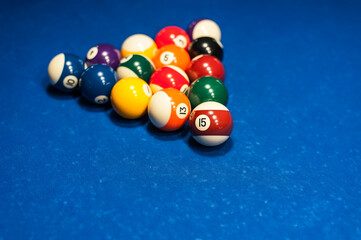 multicolored billiard balls lie in a triangle on the table