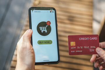 woman shopping online with credit card at coffee shop in outdoor.close up hand holding smartphone