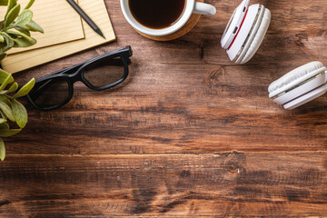 top view working desk with headphone and notebook, coffee cup on wooden table background