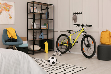 Sports equipment in stylish teenager's room interior