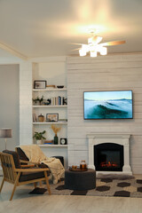 Cozy living room interior with comfortable armchairs and decorative fireplace