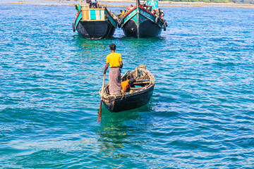 Obraz premium People at the touristic boat in Chera Dwip, Bangladesh, Water public transport in the city. Tourist boat in the sea on summer holiday.