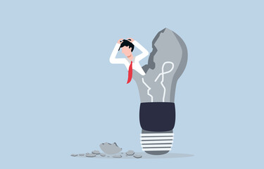 Loss of creative ideas in business, burnout from overwork, afraid of business failure concept. Stressed businessman holding head and stucking inside broken light bulb.