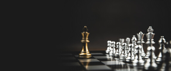 Close-up king chess standing first on chess board concepts challenge or battle fighting of business...