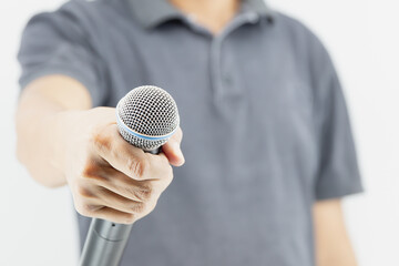 Microphone public speaking background, Close up hand holding microphone for speaker speech presentation stage performance and declaration publication or interview.