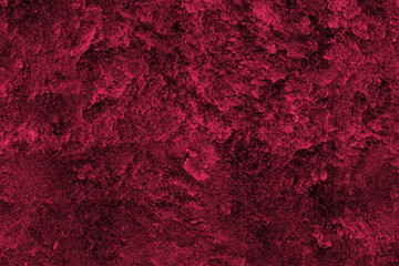 Dark red color rough concrete wall surface with heavy grunge texture