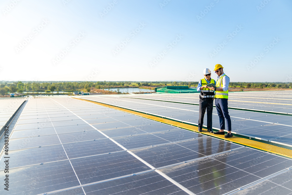 Wall mural professional engineer using drone and digital tablet maintaining solar cell panels together on build