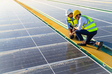 Professional engineer using drone and digital tablet maintaining solar cell panels together on building rooftop. Technician working on ecological solar farm. Renewable clean energy technology concept © CandyRetriever 