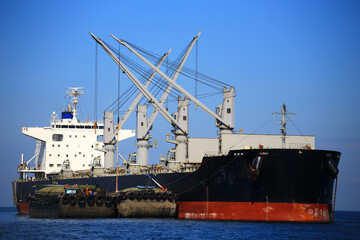 container ship commercial vessel alongside in port for loading and discharging containers services in maritime transports in World wide logistics