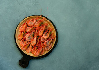Shrimps on a white plate, against the background