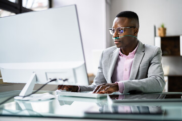 African Man Using Phone With Nasal Oxygen Cannula