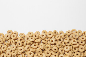 Sweet tasty corn rings on white background, top view