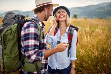 Romantic couple sharing headphones outdoor and listening music