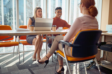 A young female applicant and young commission having a pleasant talk during an interview for a job....