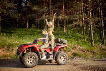 Young girls have fun while riding quad in the nature. Riding, nature, friendship, together © luckybusiness