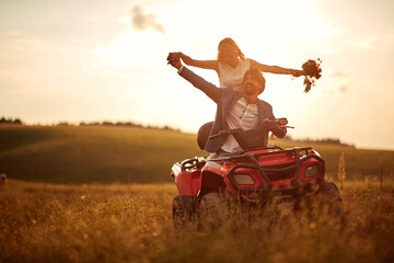 Wedding in nature.Happy  man and woman enjoying a quad atv vehicle at nature © luckybusiness