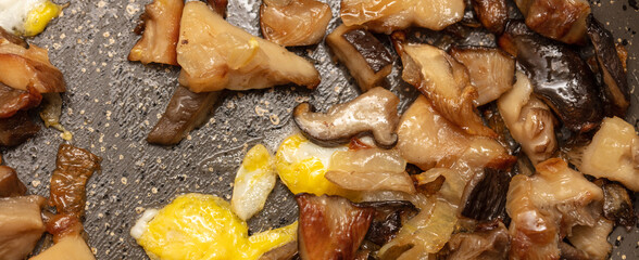 Fried mushrooms with onions in a pan.