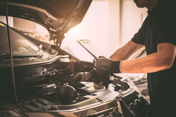 Close-up hand auto mechanic using the wrench to repairing car engine problem. Concepts of check and...