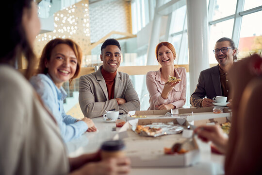 Young business team has a friendly talk during a lunch break in the company building. Business, people, company