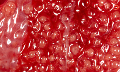 Red fish caviar as an abstract background.