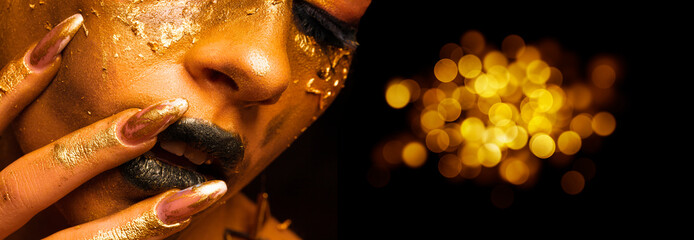 Beauty fashion model girl with golden make-up and body on black background. Golden body art. The...