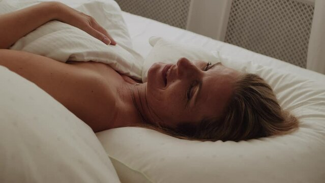 Woman Smiling In Bed As She Wakes Up