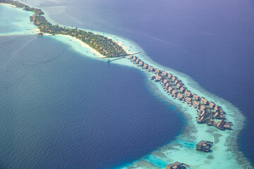 Fantastic aerial landscape, luxury tropical resort or hotel with water villas and beautiful beach scenic. Amazing bird eyes view in Maldives, landscape seascape aerial view over Maldives, traveling