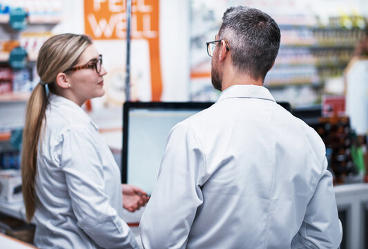 Theyve Got Your Back For All Your Medical Needs. Rearview Shot Of Two Pharmacists Working In A Pharmacy.