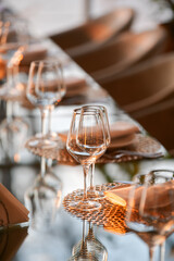 Luxury restaurant table decorations. Glasses and plates are set up on this beautiful table for serving the dinner during a beautiful sunset.