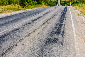Tire tracks on the asphalt road. Brake traces