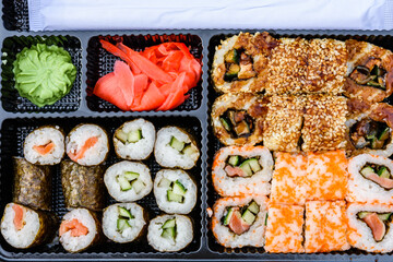 Set of the different sushi in a plastic box. Top view