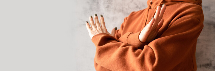 young woman with arms crossed at chest demonstrates break the bias symbol of iwd women's ...