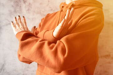 young woman with arms crossed at chest demonstrates break the bias symbol of iwd women's ...