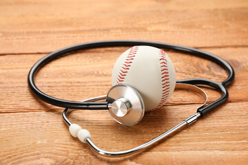 Baseball ball and stethoscope on wooden table. Doping concept