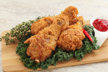 Fried chicken drumsticks with tomato sauce