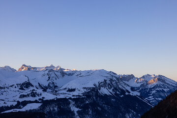 Amazing sunrise with a big mountain in front called Grosser Mythen with sun rays on top. Epic long exposure shot in the heart of Switzerland. Wonderful scenery with the mountain who get shined.