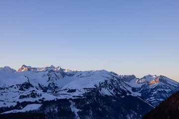 Amazing sunrise with a big mountain in front called Grosser Mythen with sun rays on top. Epic long exposure shot in the heart of Switzerland. Wonderful scenery with the mountain who get shined.