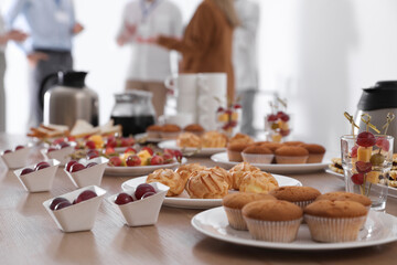 Table with different delicious snacks indoors. Coffee break