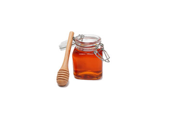 glass jar filled with honey on a white background