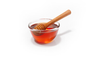 glass jar filled with honey on a white background