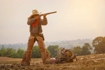 Vintage action shot of a cowboy with a gun in hand at sunset.