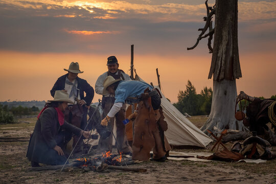 Action image, vintage style of the cowboy group. Sit back and relax and have coffee in the morning camping in the golden light of the morning sun.