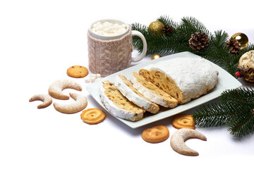 Sliced Traditional Christmas stollen cake with marzipan and dried fruit isolated on ceramic plate