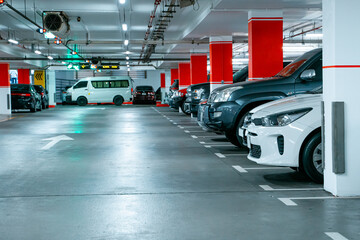 Parking garage underground interior, pedestrian crossing. Illuminated underground car parking...