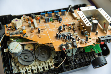 Connectors and parts on the board of an old tape recorder.