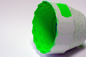  green price tag in a roll at an angle on a white background