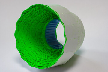  green price tag in a roll at an angle on a white background