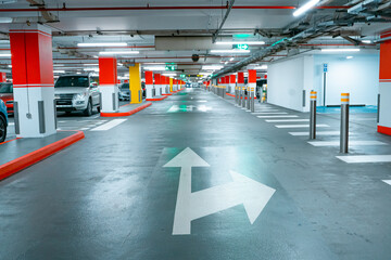 Parking garage underground interior, pedestrian crossing. Illuminated underground car parking...
