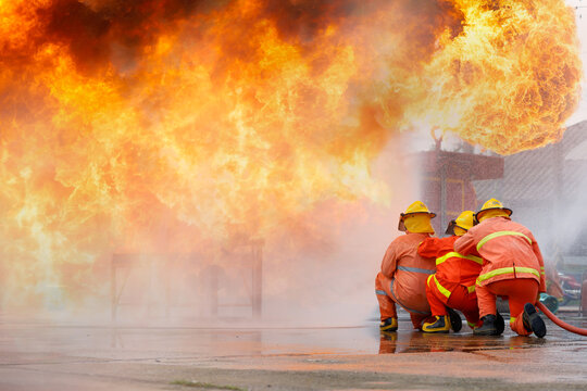 Fireman,Firefighter training Firefighters using water and fire extinguishers to fight the flames in emergency situations. in a dangerous situation All firefighters wear firefighter uniforms for safety